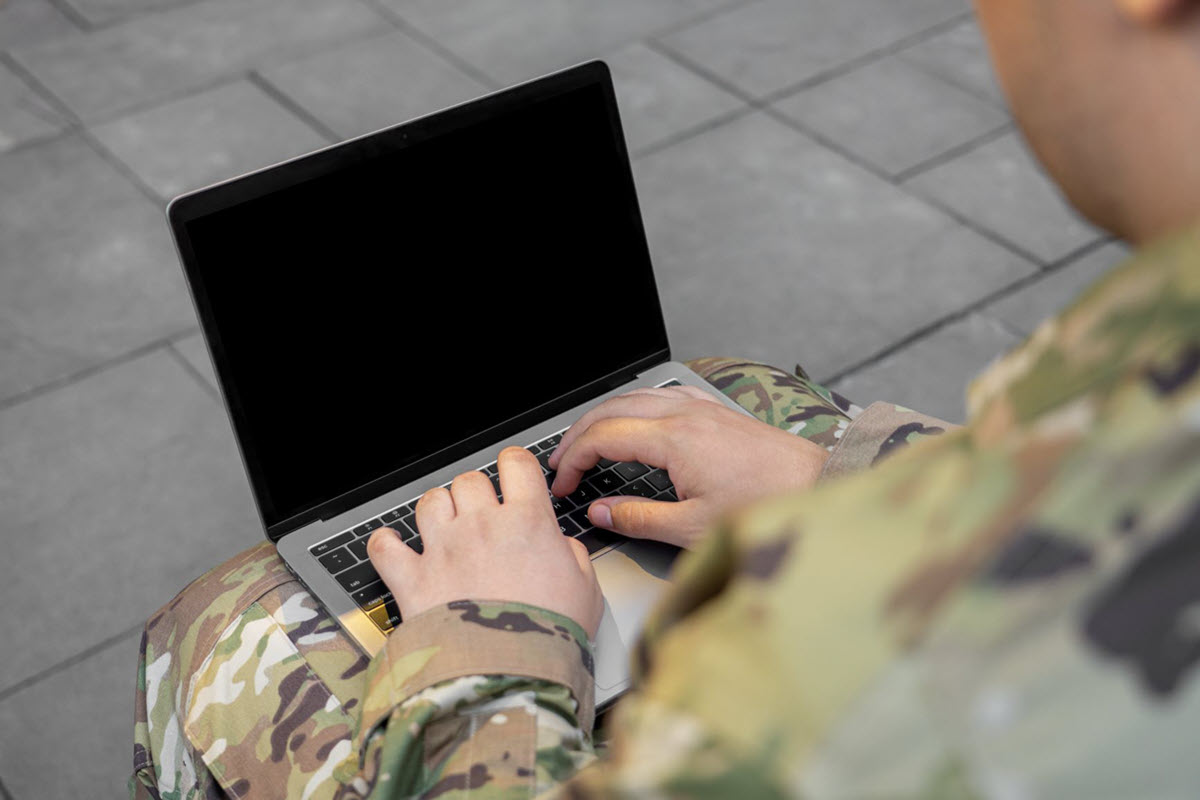 Veteran typing on a laptop.